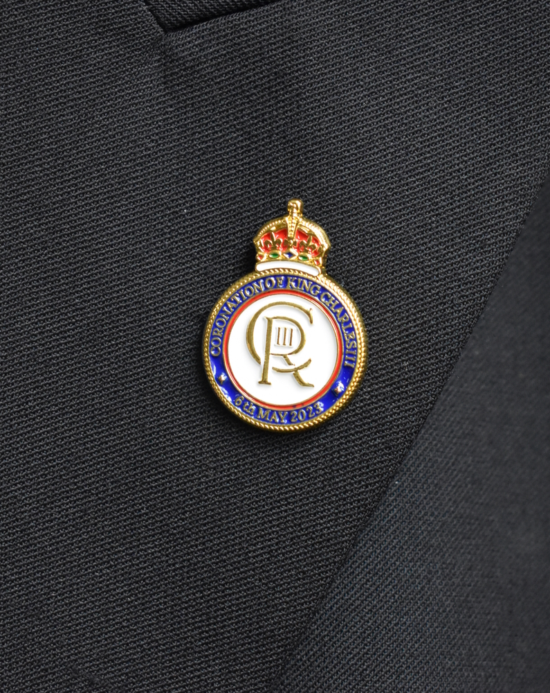 King Charles III Coronation Pin Badge on jacket lapel