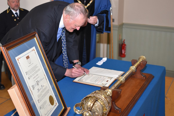 Rodney Duggua RD BA(Hons) accepting the Freedom of the City of Chichester by signing the Freedom Roll - 26 April 2023