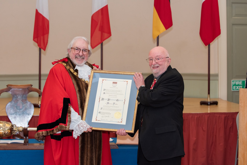 Roger Gibson receiving the Honorary Freedom of the City of Chichester, 23 January 2024, the Mayor, Councillor Craig J L Gershater presenting the Freedom Scroll
