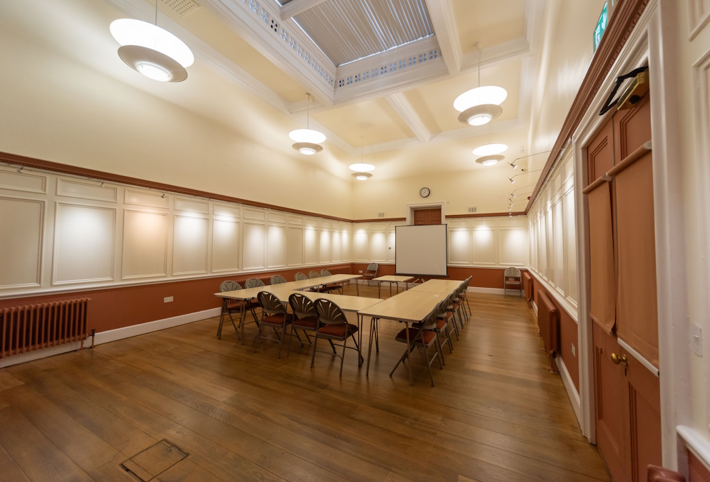 Photo showing Old Court Room set up committee meeting style, taken from the back of the room